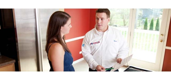 Pest Technician Talking with a Women about Pest Services in Northfield, IL