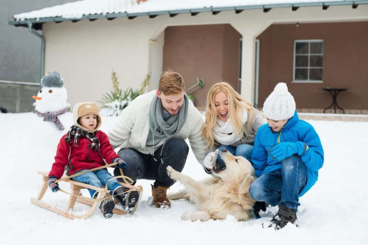 A family having fun together in the snow during the winter season in Illinois