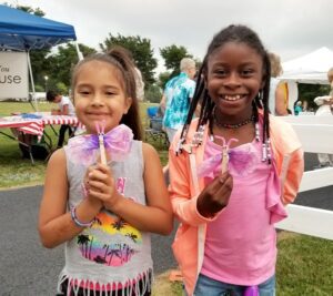 2 girls showing off bug toys