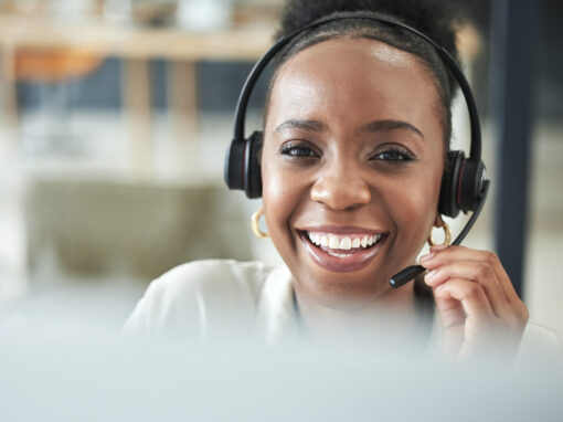 Close-up of a person wearing a headset microphone while working at a customer service desk